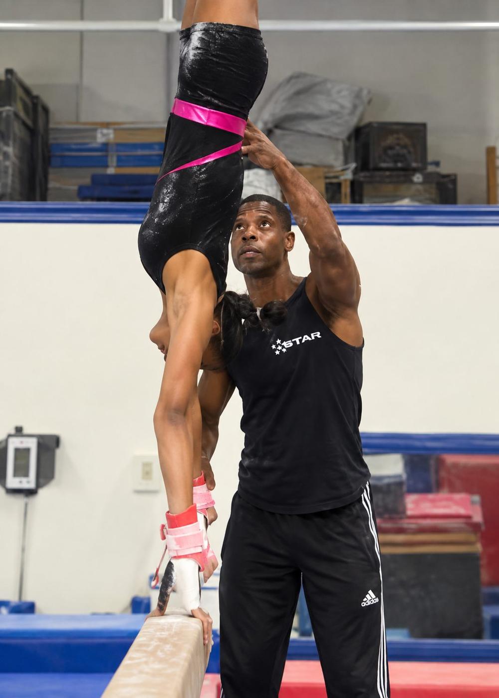 Leon Williams Jr. coaching a gymnast